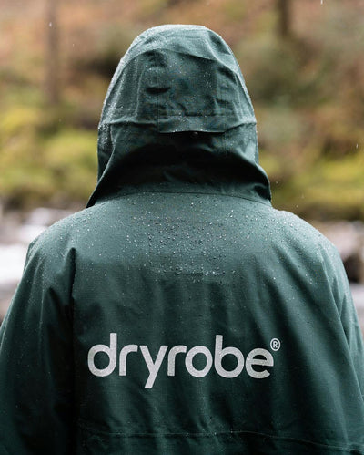 Dryrobe® green poncho in front of river