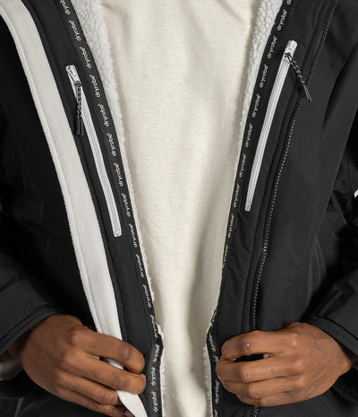 *MALE* Close-up of a person wearing a black zip-front jacket with a white sherpa lining and white zipper tape printed with the brand name 'pedalo'.