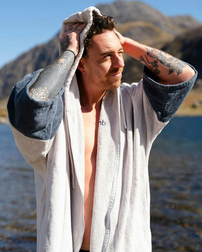 *MALE* by water wearing Dryrobe® Zip towel (nimbus cloud)