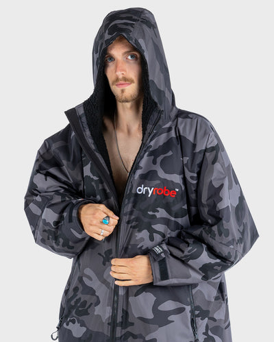 Man wearing Black Camo dryrobe® Advance Long Sleeve with hood up 