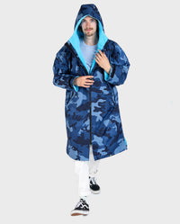 **MALE** Man walking toward 
camera wearing dryrobe Advance Long Sleeve changing robe in Blue Camo Blue with hood up 