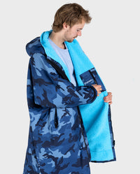 **MALE** Man wearing dryrobe Advance Long Sleeve changing robe in Blue Camo Blue showing the inner lining and internal pocket