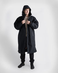 *MALE* Person wearing a black Nexus over a white shirt on a white background
