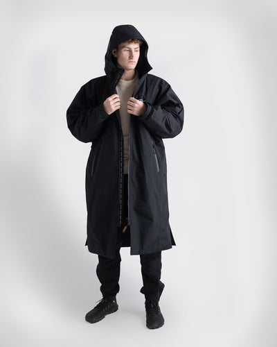 *MALE* Person wearing a black Nexus over a white shirt on a white background
