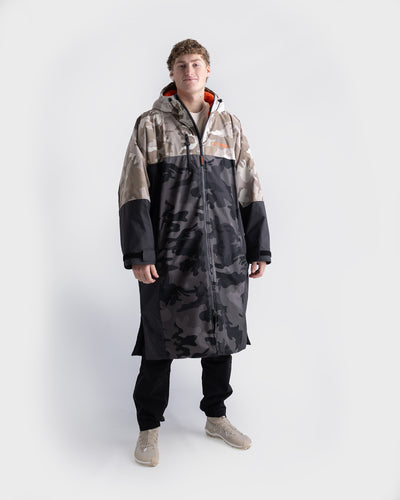 *MALE* Person wearing a long, multi-colored Dryrobe Nexus on a white background