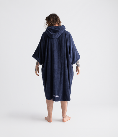 *MALE* Person wearing a navy blue towel robe with 'dryrobe' branding on a white background