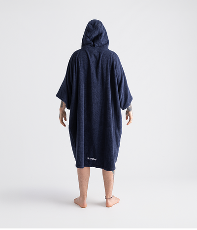 *MALE* Person wearing a navy blue hooded towel robe with 'dryrobe' branding on a white background