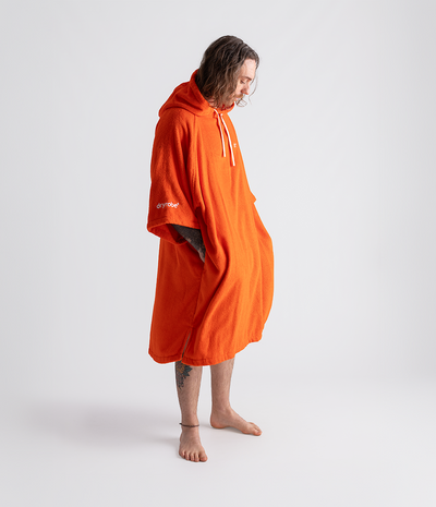 *MALE* Person wearing an orange hooded towel robe with a brand logo on a white background