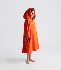 Person wearing an orange hooded towel robe with 'dryrobe' branding on a white background