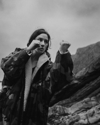 Person in a coat with a mountainous background