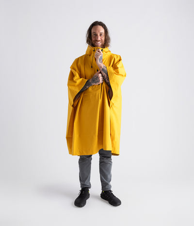 *MALE* wearing  Yellow Dryrobe® Waterproof Poncho zipped up with hood down 
