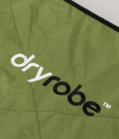 Close-up of an olive green Dryrobe garment or fabric panel with large white and black 'dryrobe' branding printed diagonally across it.