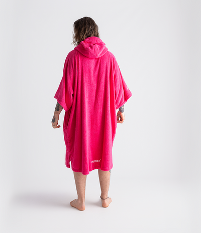 *MALE* Person wearing a bright pink hooded towel robe on a white background