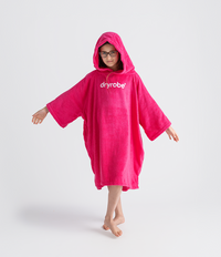 Person wearing a pink 'dryrobe' towel robe on a white background