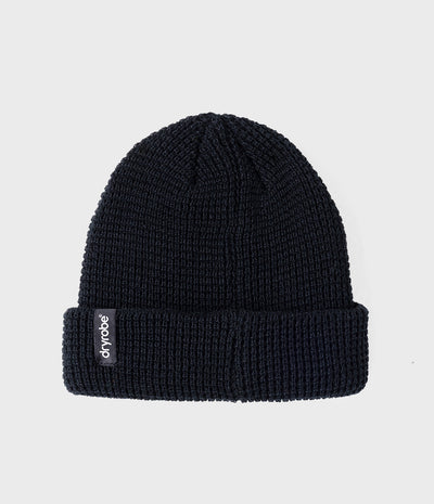 A dark navy blue ribbed knit beanie hat with a folded cuff, featuring a small black brand tag on the side that reads 'dry robe'. The beanie is photographed against a clean, light gray background.