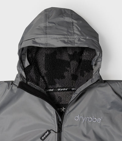 *MALE* Close-up of a gray Dryrobe hood and a black fleece-lined interior. The Dryrobe logo is visible on the chest and zipper pull.