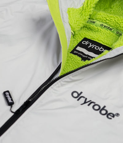 *MALE*Close-up of a white garment with green lining and 'dryrobe' branding.