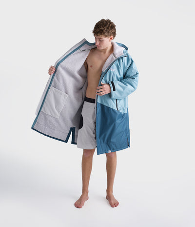 *MALE* Person wearing a blue and gray hooded Dryrobe on a white background