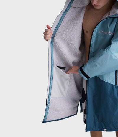 *MALE* Person wearing a blue and gray Dryrobe with 'Dryrobe' branding on a white background