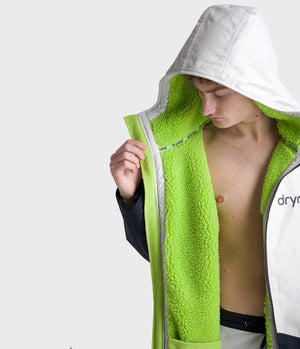 *MALE* Person wearing a green and white Dryrobe with a hood on a white background