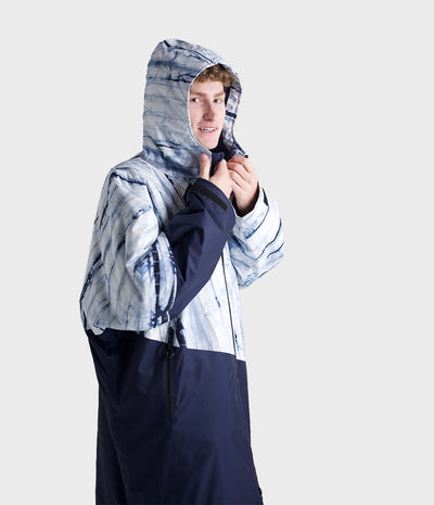 *MALE* Person wearing a unique Dryrobe with a hood and blue and white pattern on a light gray background