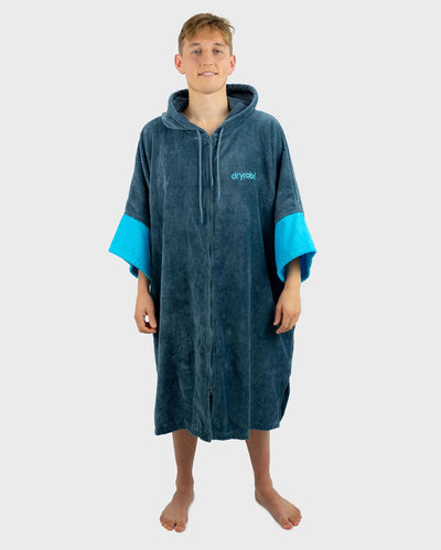 *MALE* Person wearing a blue and grey hooded towel robe with 'dryrobe' branding on a white background