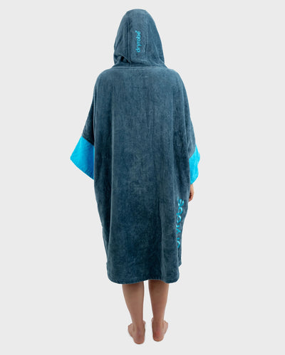 Person wearing a blue hooded towel robe with branding on a white background
