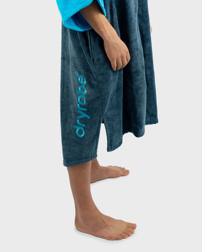 *MALE* Person wearing a blue towel with 'dryrobe' branding on a white background
