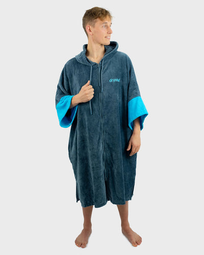 *MALE* Person wearing a blue and grey towel robe with 'Dryrobe' branding on a white background