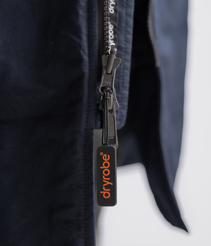 Close-up of a zipper on a black garment with 'Dryrobe' branding.
