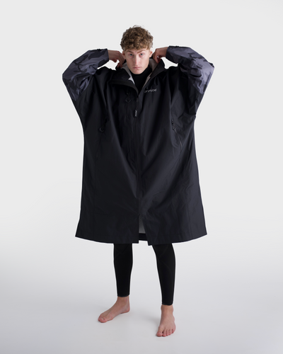 *MALE* Person wearing a black raincoat on a white background
