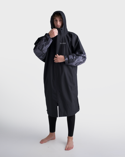 *MALE* Person wearing a black raincoat with a hood on a white background