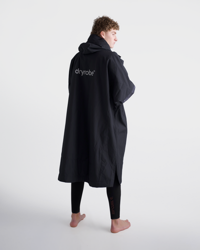 *MALE* Person wearing a black Dryrobe on a white background