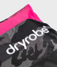 Close-up of a Dryrobe bag showing a black and gray camouflage pattern with a bright pink top panel and large white 'dryrobe' branding.
