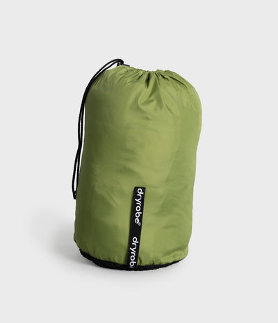 An olive green Dryrobe drawstring bag with black cords and a black bottom trim, featuring a vertical black brand tag with white text, set against a light gray background.
