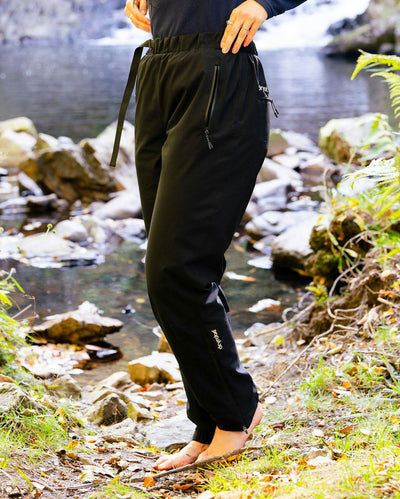 Woman stood by river wearing dryrobe® Thermal Trousers