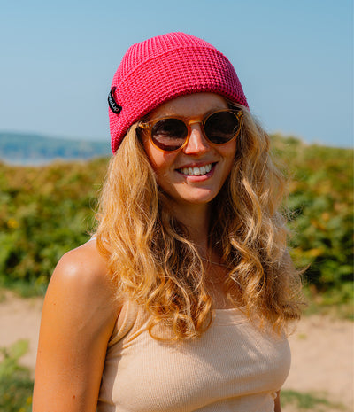 Women wearing a pink waffle beanie