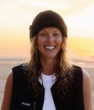 smiling woman wearing a black beanie