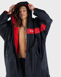 Man  wearing Black Red Red dryrobe Advance Long Sleeve REMIX Range with hood up