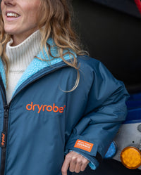 Girl smiling wearing Limited Edition RNLI dryrobe Advance