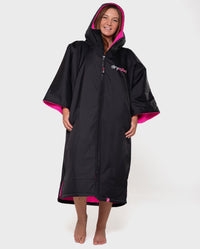 Woman wearing Black Pink dryrobe® Advance Short Sleeve with hood and zip up