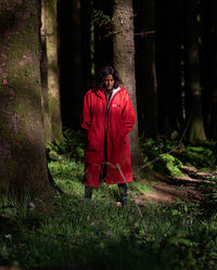 Woman walking through woods, wearing Red Grey dryrobe® Advance Long Sleeve