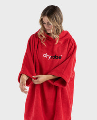 Woman holding sleeve of Red Organic Towel dryrobe®
