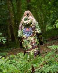 Woman walking through woods with back to the camera, wearing Red Bull Hardline dryrobe® Advance Long Sleeve