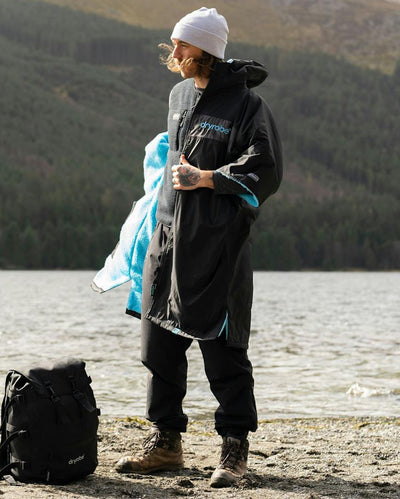Adult male by lake wearing black blue remix Dryrobe®
