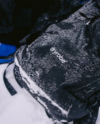 dryrobe® Eco Compression Backpack on snowy ground, covered in snow 