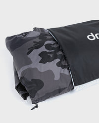Black Camo dryrobe® Advance folded halfway into dryrobe® Cushion Cover