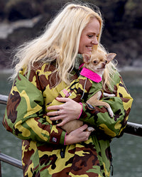 Woman holding small dog, wearing matching Camo Pink dryrobes
