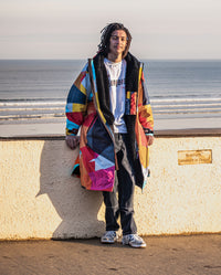 **MALE** Man leaning against wall by the sea, wearing dryrobe Advance Abstract 