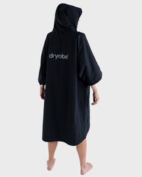 Woman with back to the camera, wearing dryrobe® Lite 